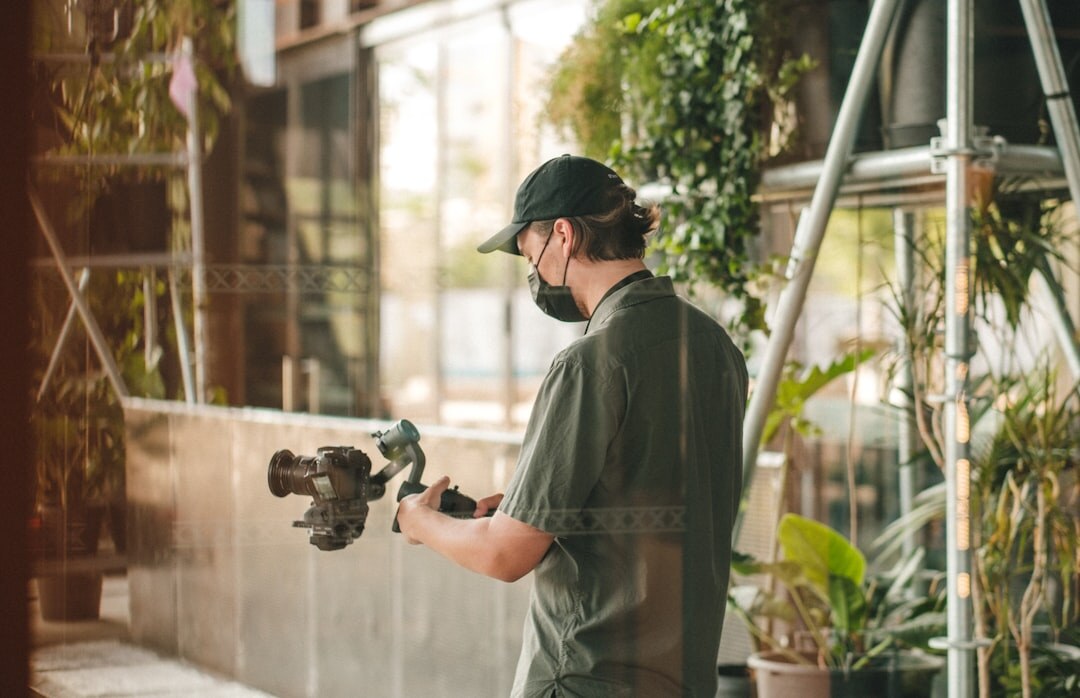 Camera operator filming with a professional broadcast camera on a studio set