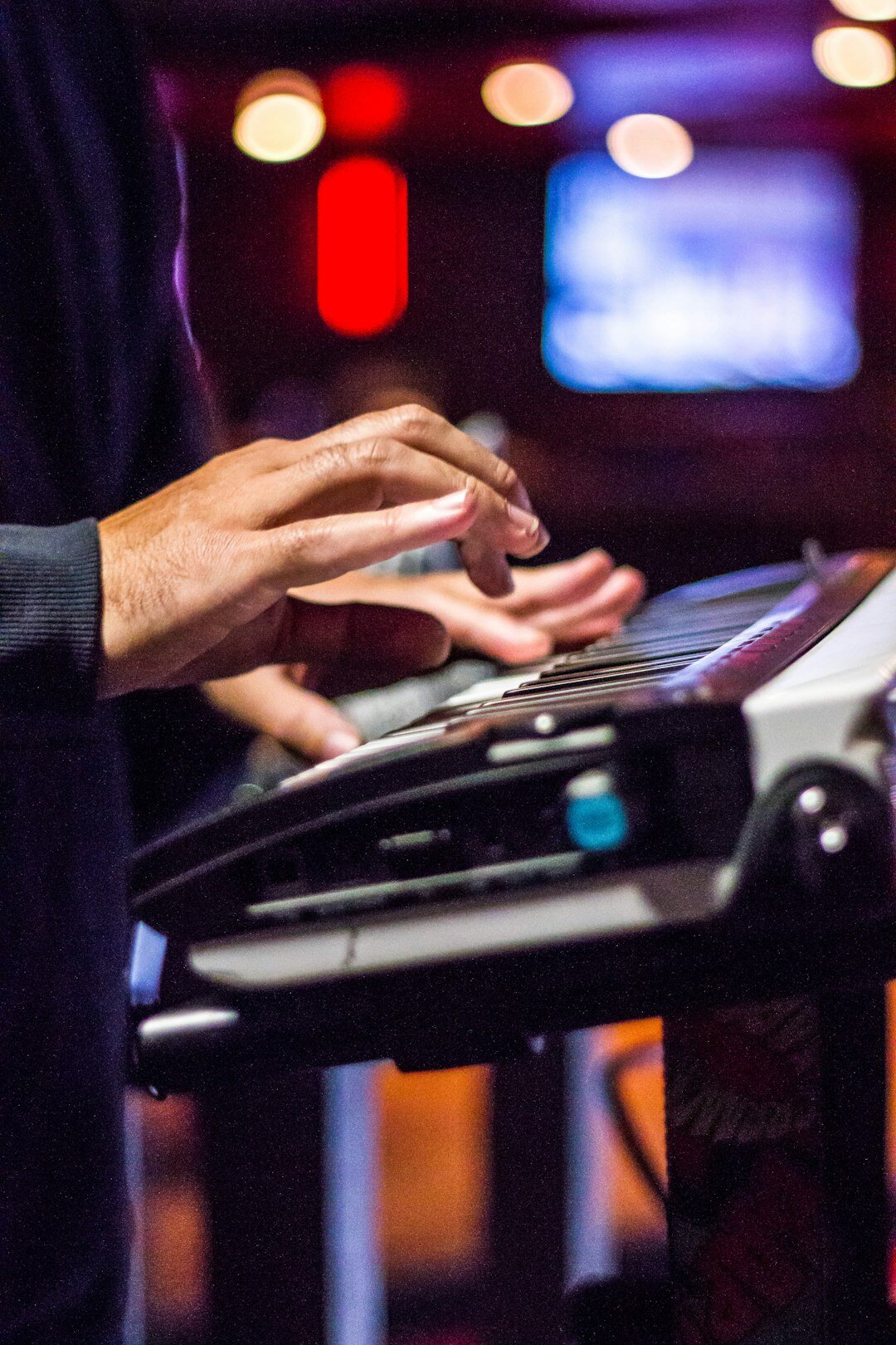 Close-up of hands operating a broadcast vision mixer switcher panel